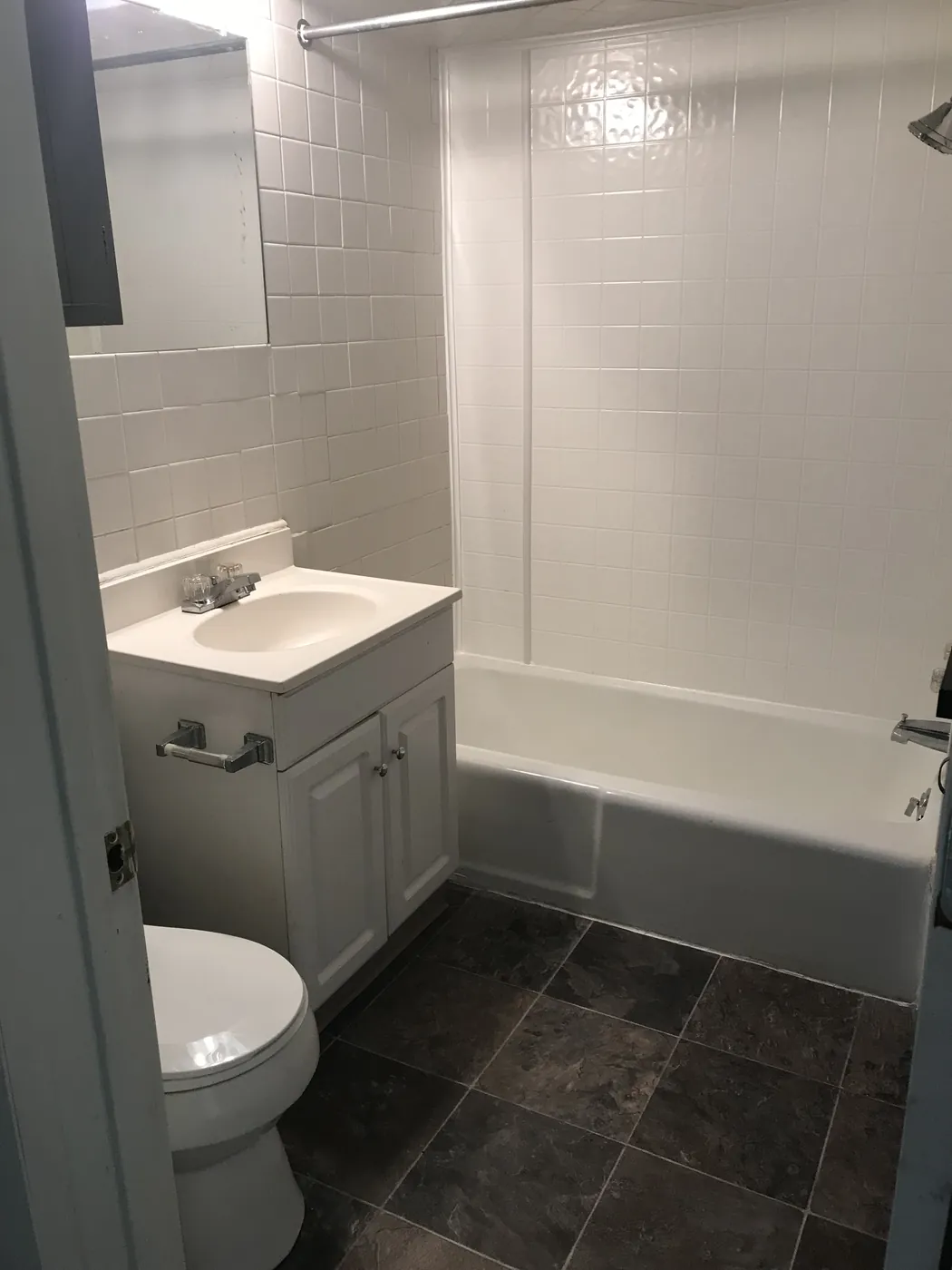Bathroom with tub and tile floor
