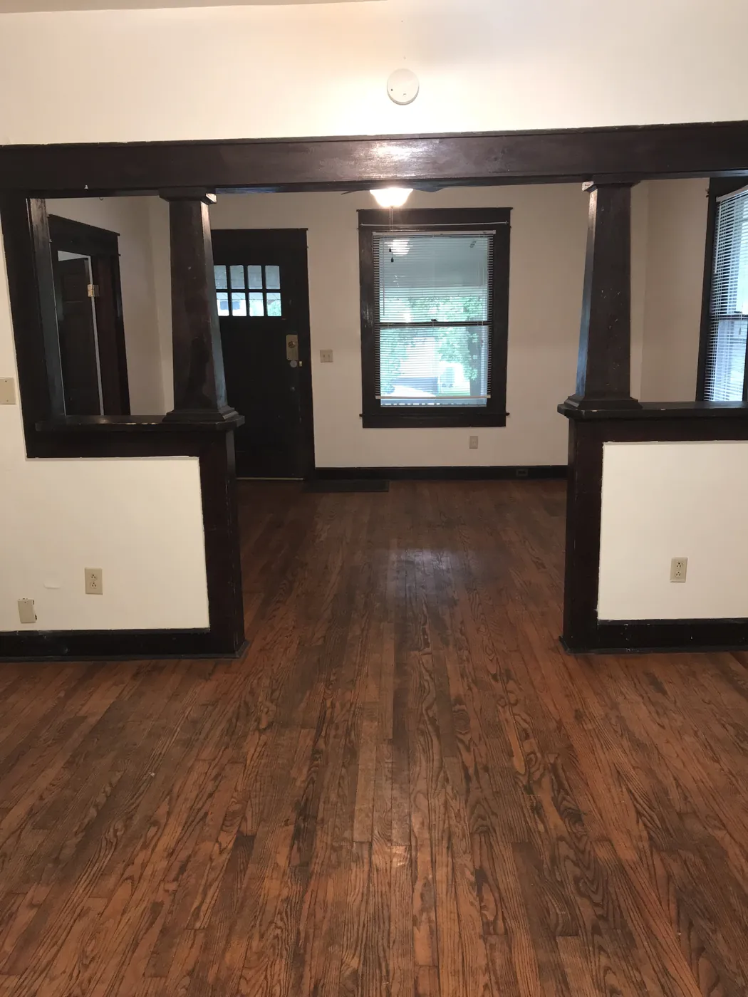 Living and dining rooms with hardwood floors and original trim