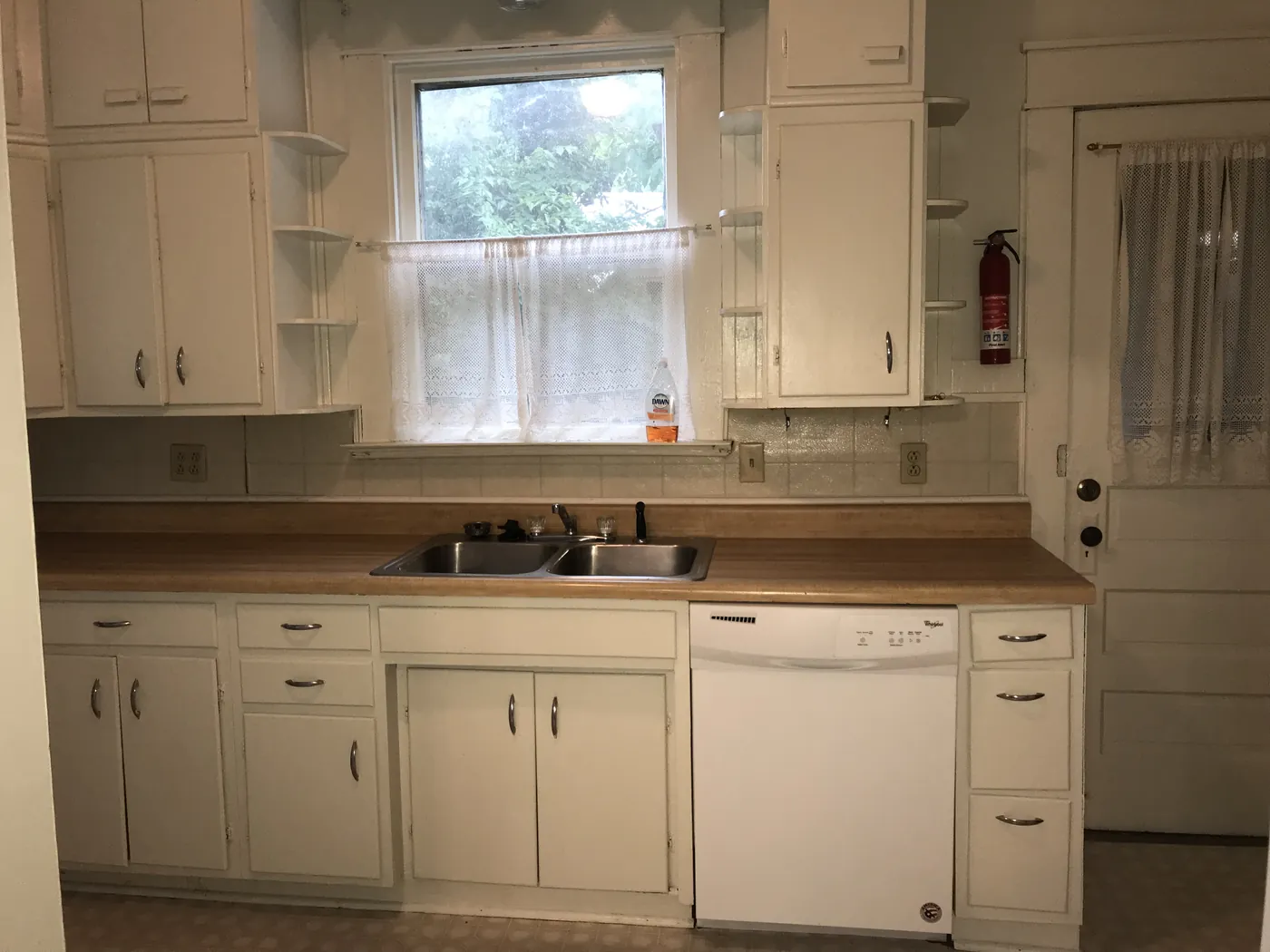 Kitchen with dishwasher and built-in cabinets