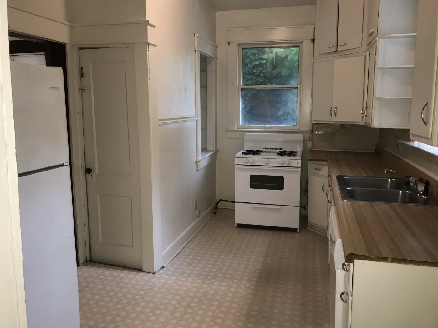 Kitchen with range and refrigerator