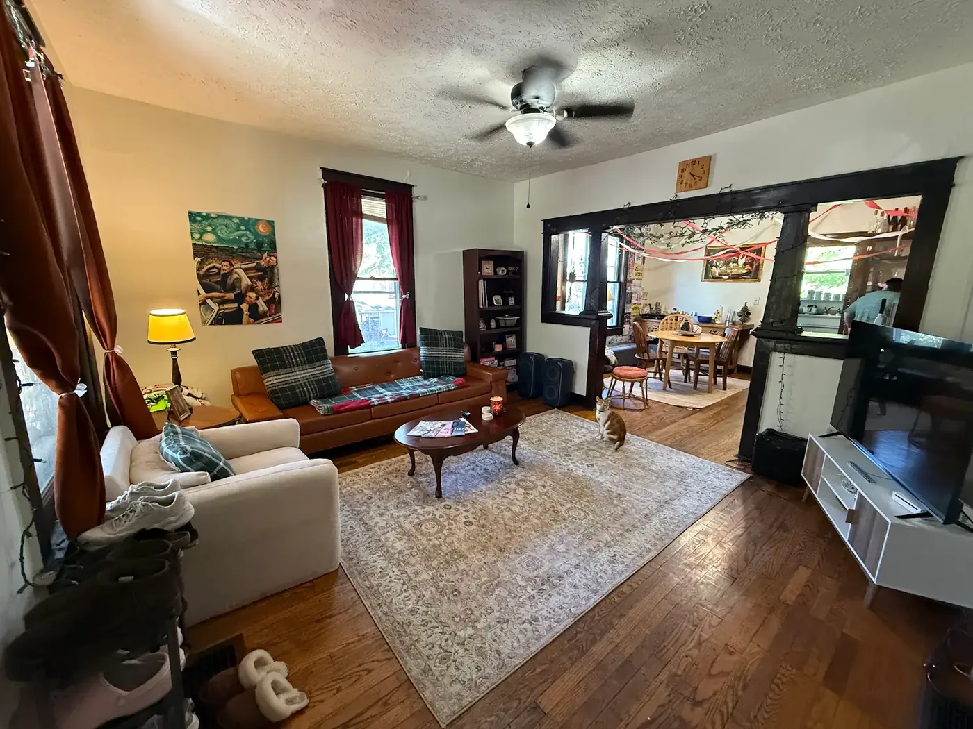 Living room with ceiling fan and hardwood floors