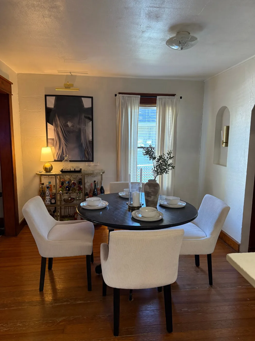 Dining room with window and arched niche